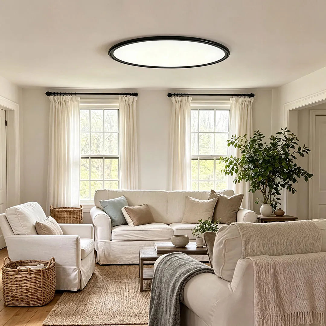 Round LED ceiling lights illuminating a bright living room with layered neutral seating and large windows.
