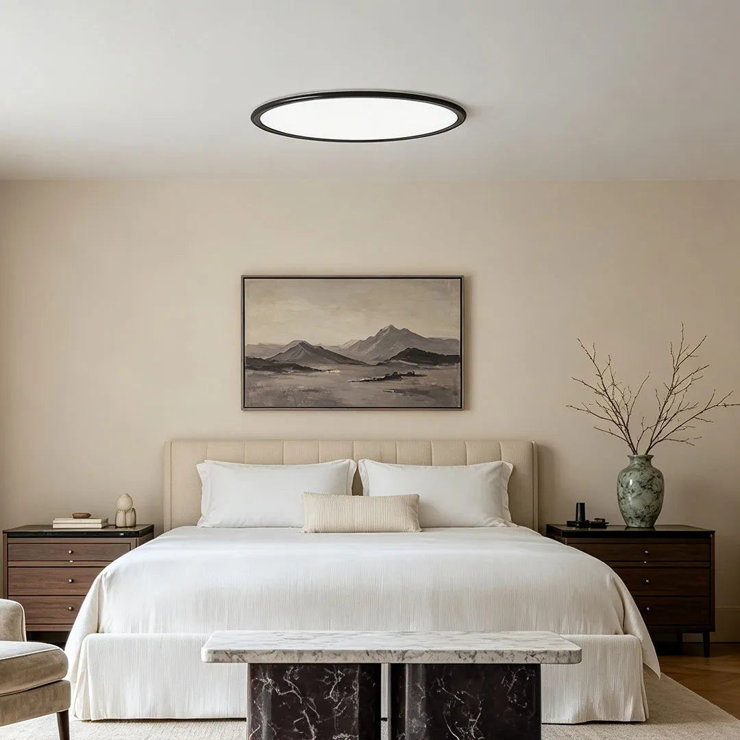 Round LED ceiling lights centered above a serene bedroom with white bedding and dark wood nightstands.