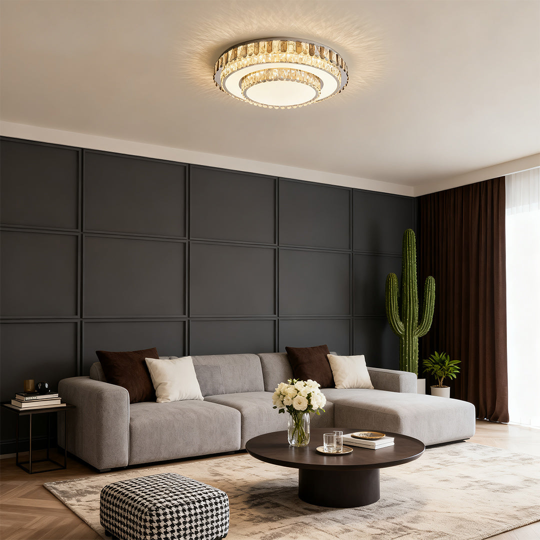 Round LED flush mount light with gold crystal rim in gray living room.