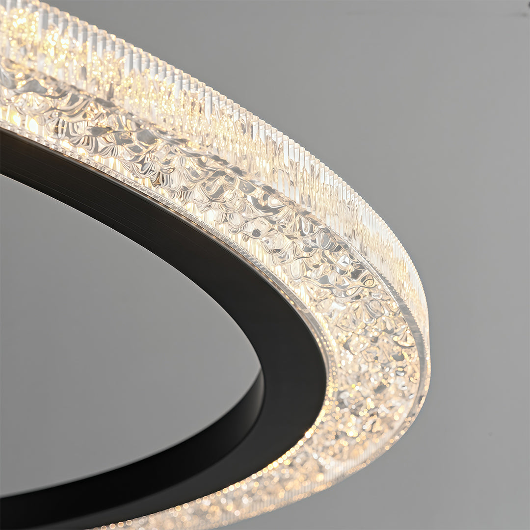 Modern luxury chandeliers close-up showcasing curved brass frame and crystal detail