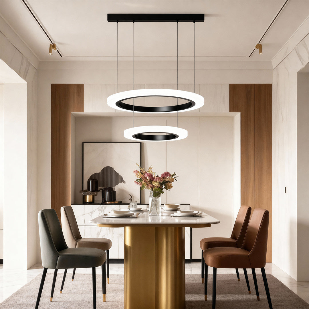 Round modern chandelier lighting contemporary dining space with brass table and upholstered chairs