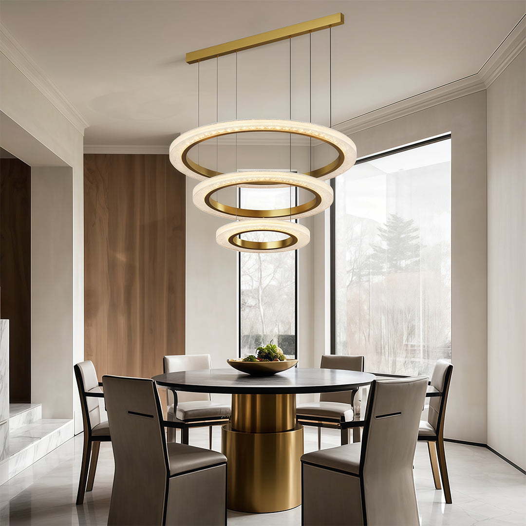 Round modern chandelier illuminating elegant dining room with round table and modern chairs