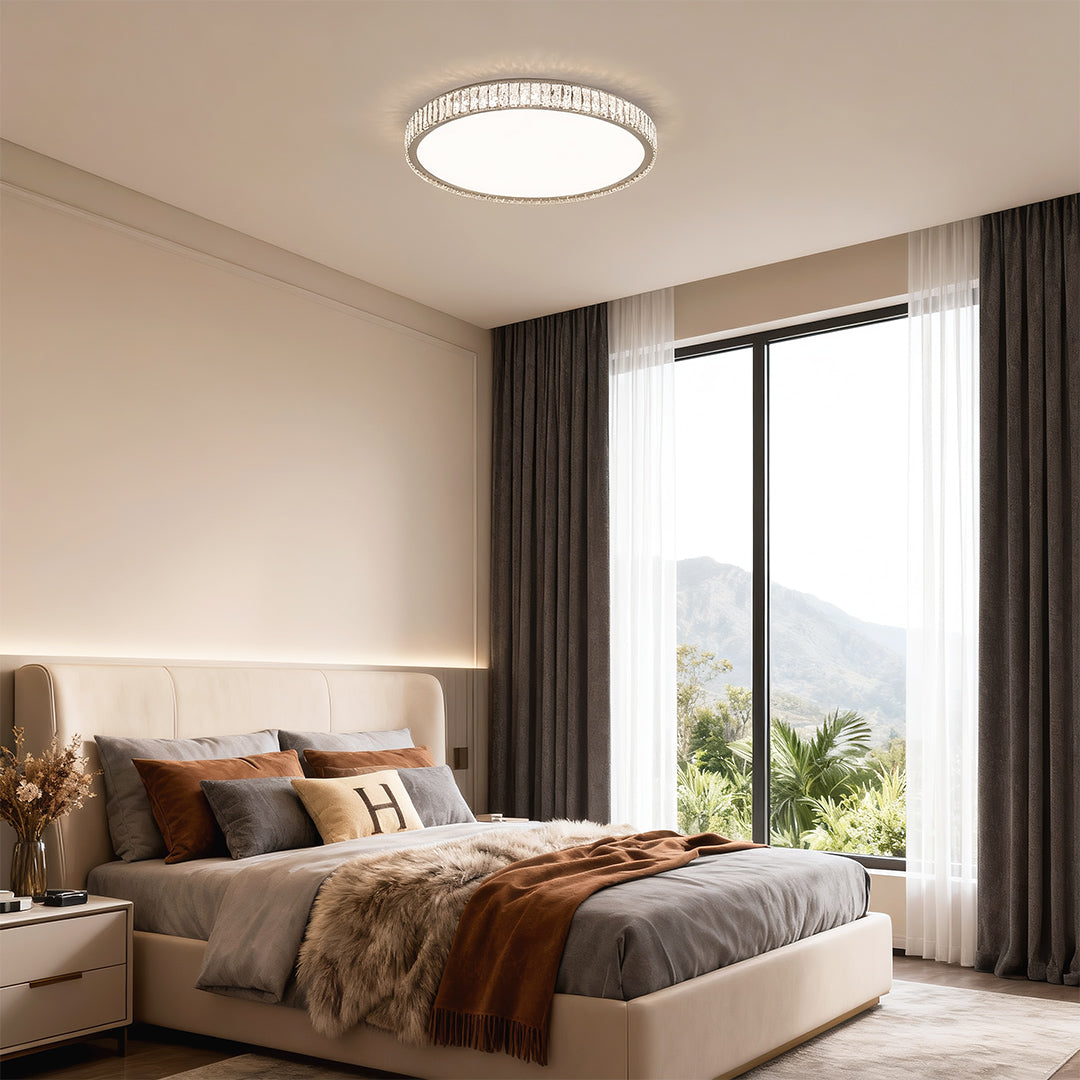 Round modern crystal flush mount lighting fixture brightening a contemporary bedroom with natural tones.