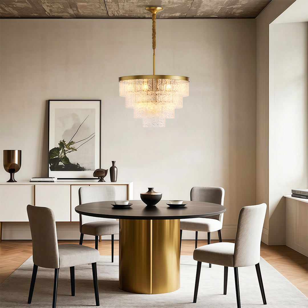 Round modern forms chandelier enhancing bright dining area with cylindrical brass table base.