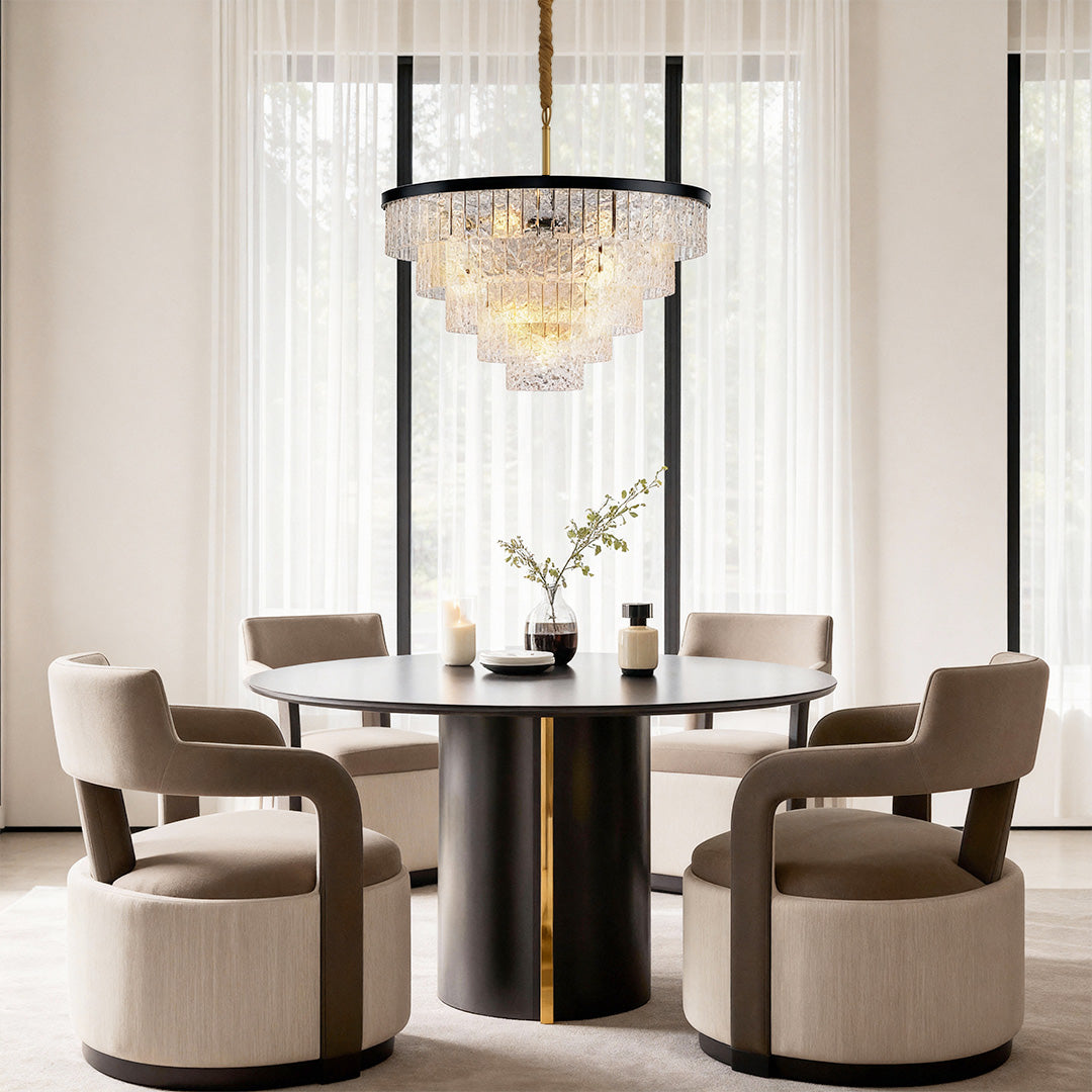 Round modern forms chandelier creating elegant focal point in contemporary dining space with velvet chairs.