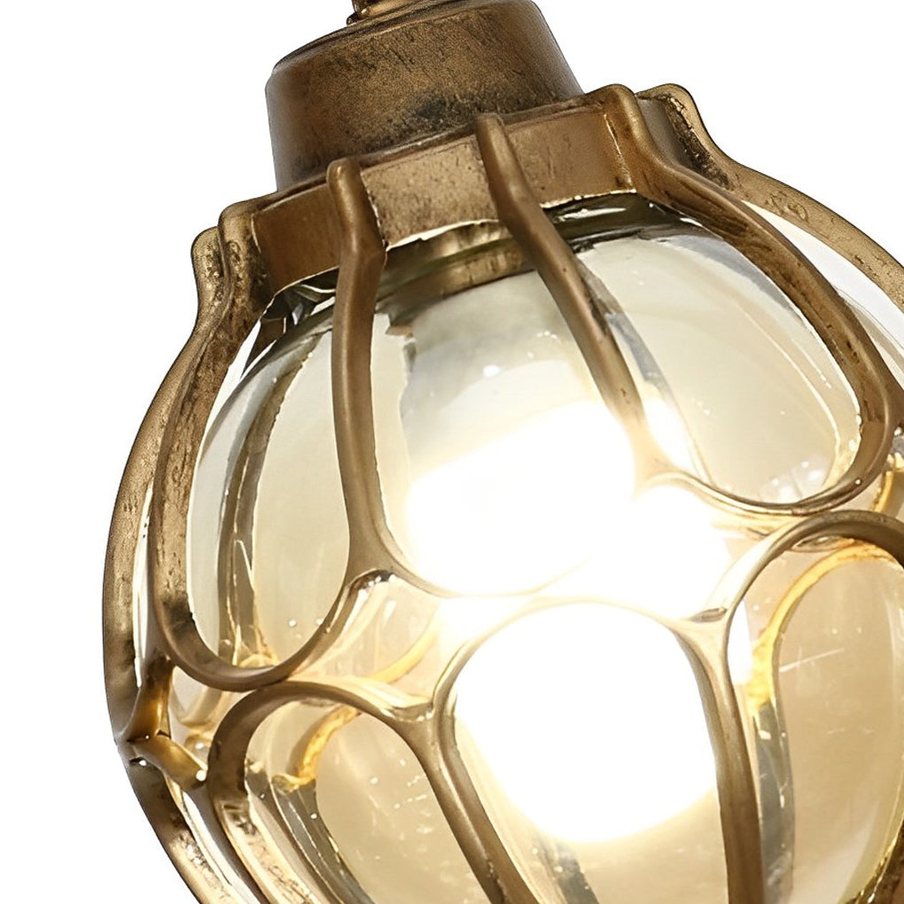 Round outdoor hanging lights with a sleek design, installed in a garden pergola.