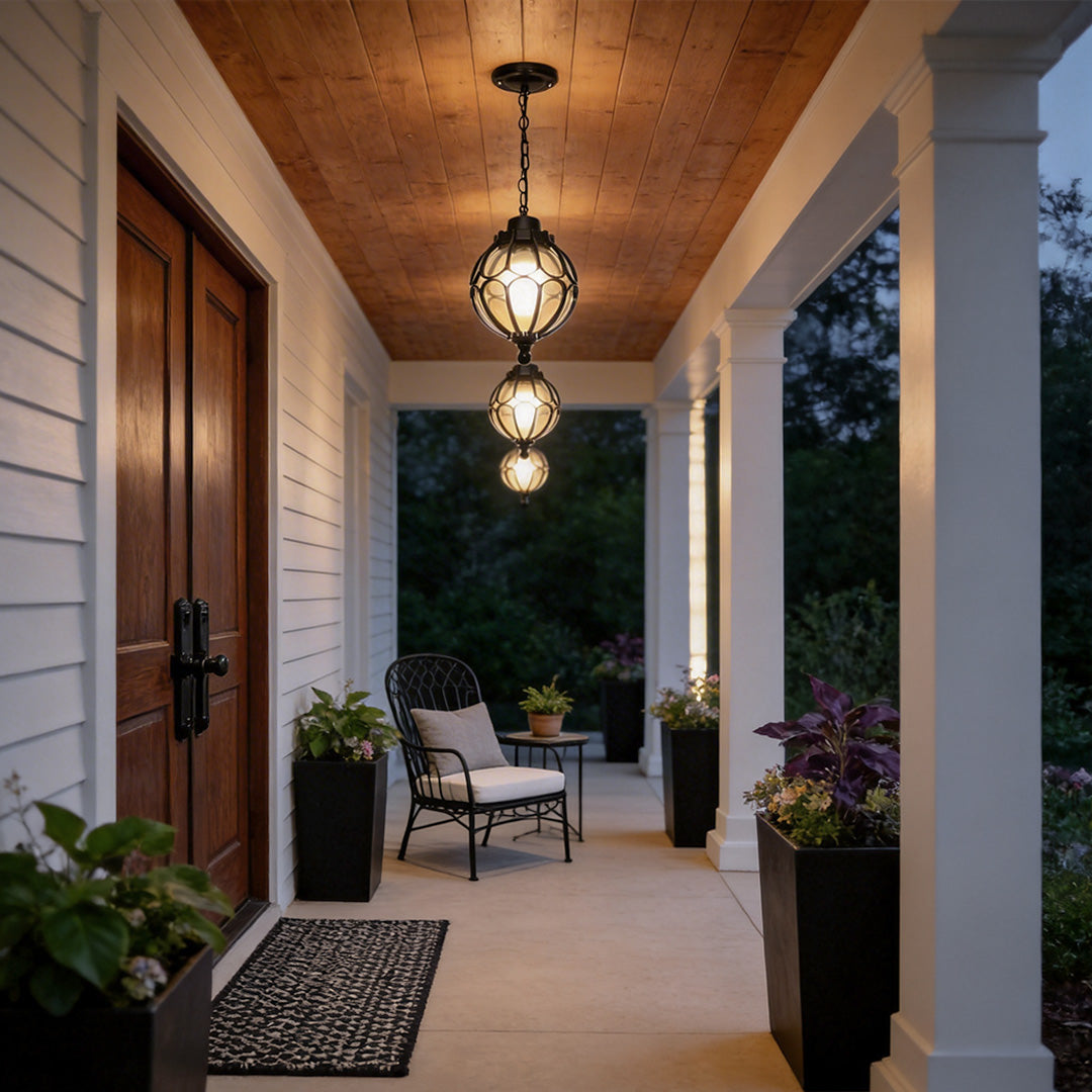 Round outdoor hanging lights with a vintage design, installed above a wooden porch.