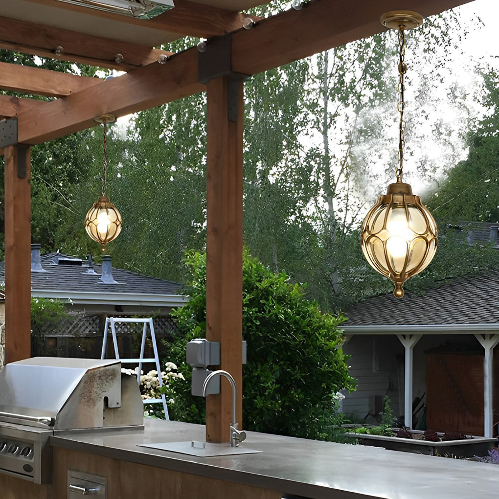 Round outdoor hanging lights providing warm illumination in a backyard dining area.