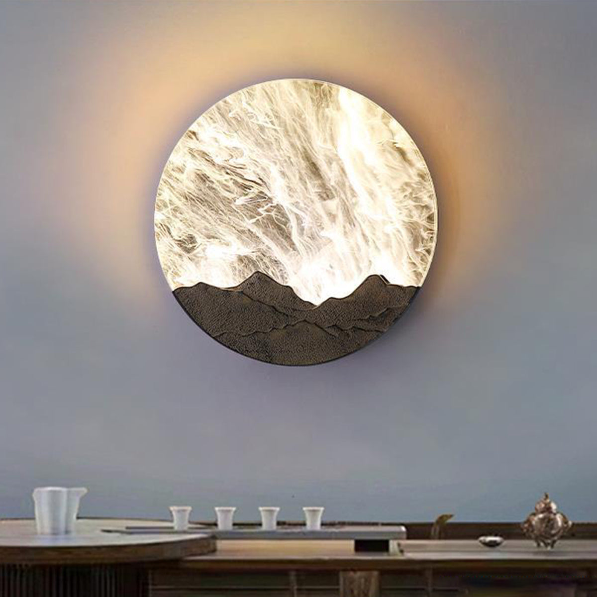 Round outdoor sconce illuminating a minimalist garden pathway with stone tiles.