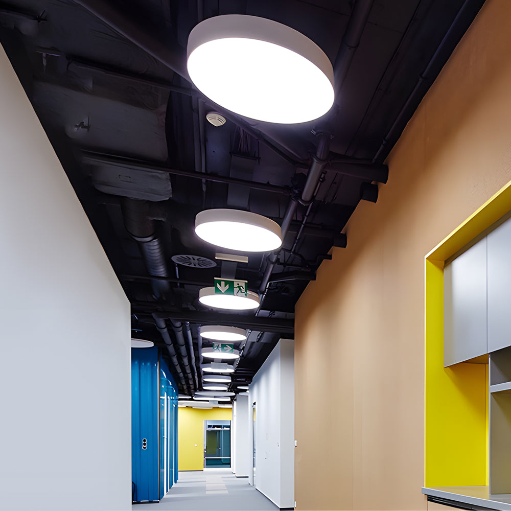 Round pendant lights providing illumination in a commercial corridor