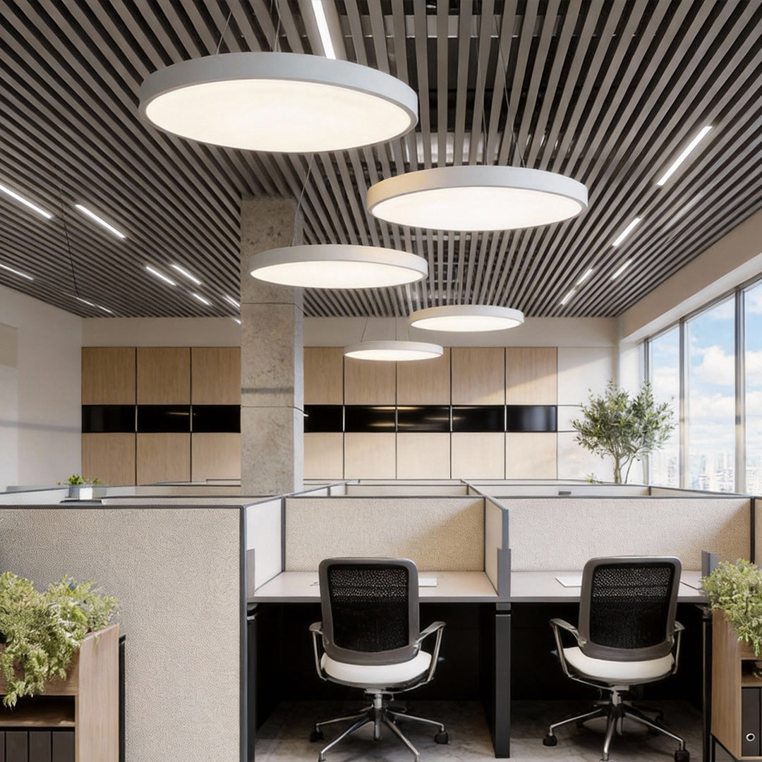 Cubicle office environment enhanced by large round pendant lights for even light distribution.