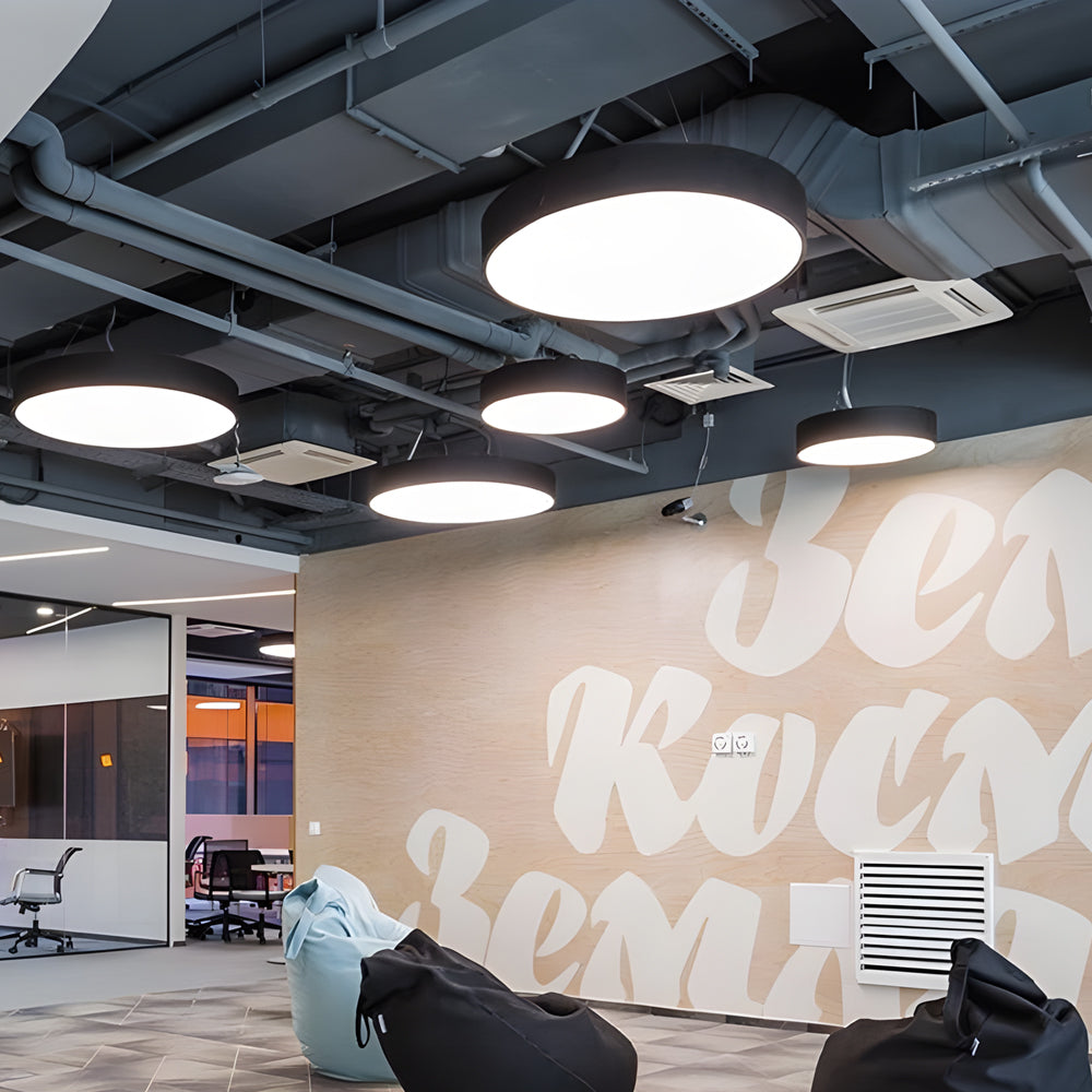 Round pendant lights used in an open ceiling office space