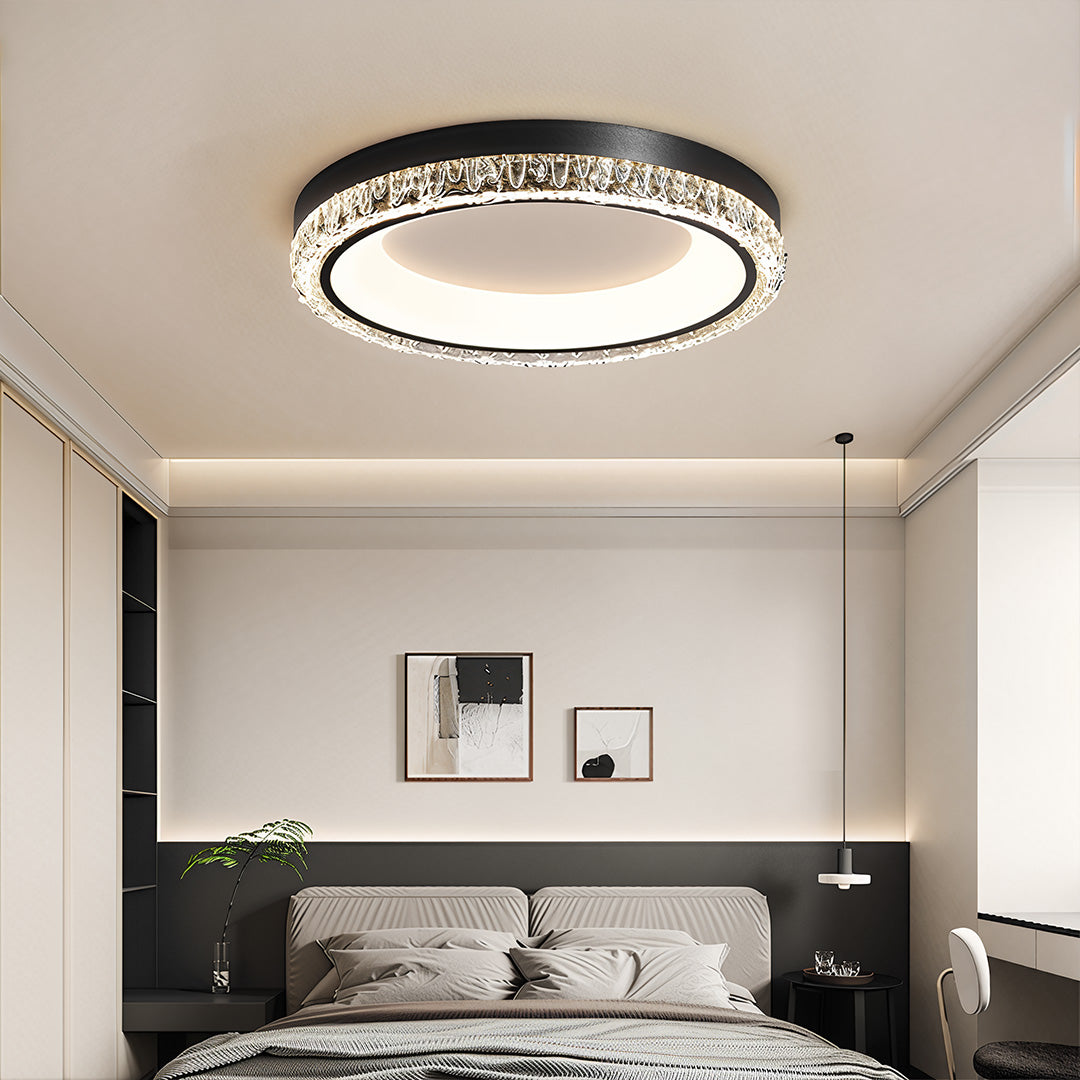Round white flush mount ceiling light with integrated LED, installed in a minimalist modern bedroom.