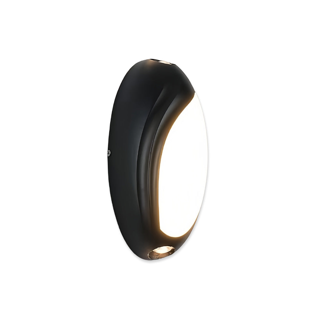Single rounded black modern up down outdoor wall light with soft warm glow on white background.