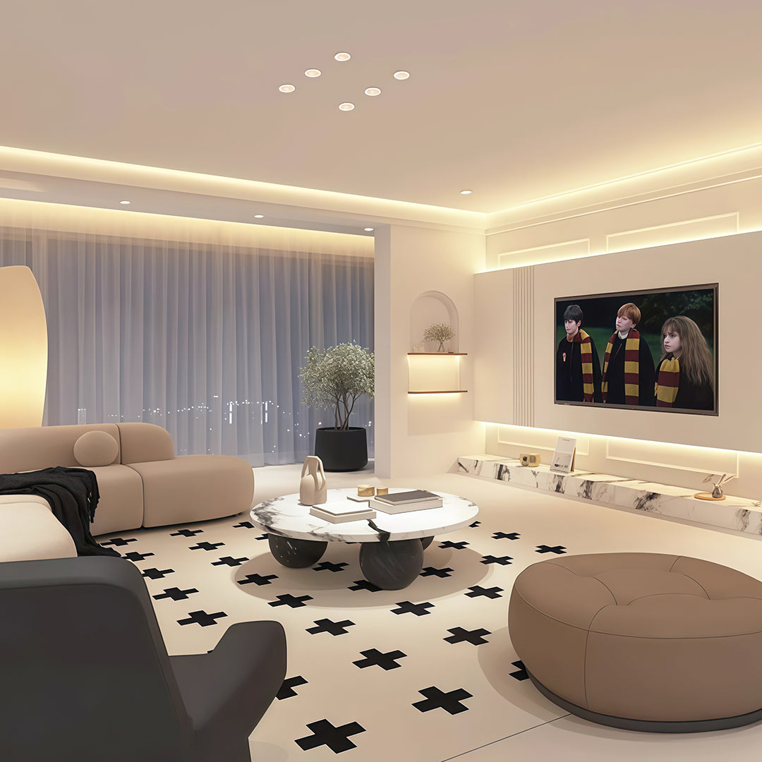 Row of accent spotlights providing ambient lighting in sophisticated living room with cove ceiling
