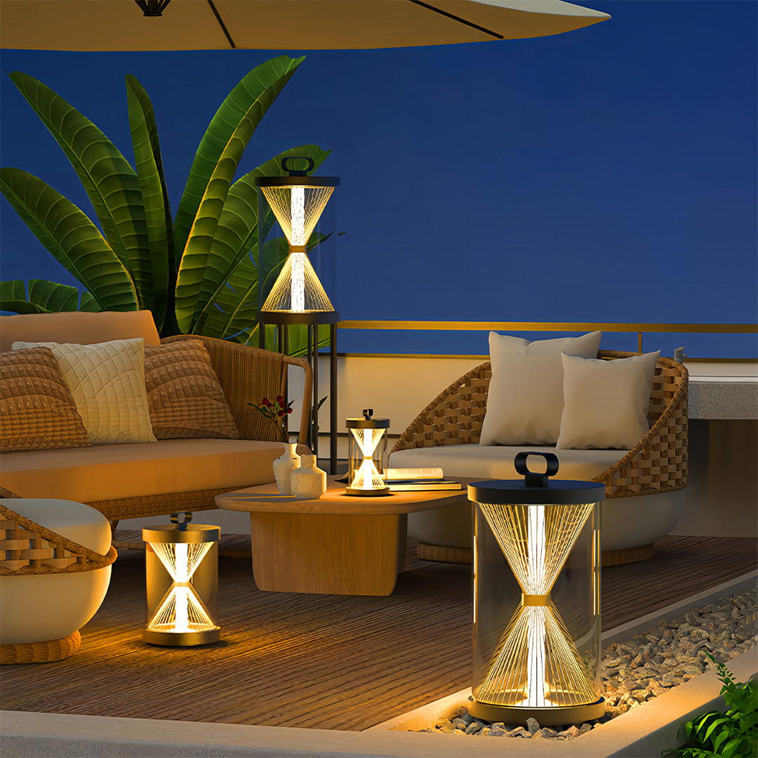 Row of black outdoor lantern fixtures on a white boundary wall with black metal fence panels, illuminating the front of a home.