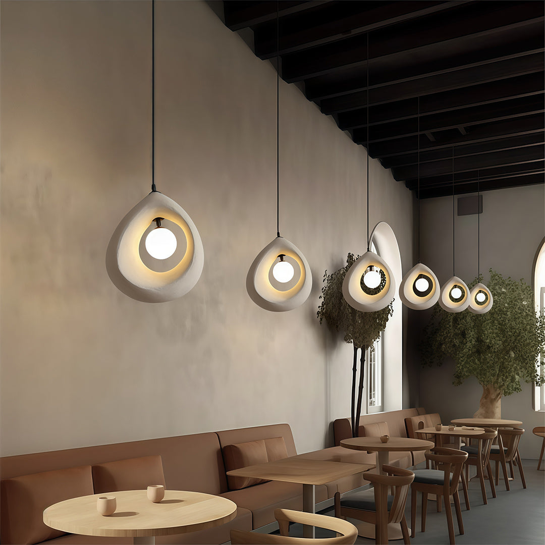 Row of Statement Pendant Lights creating warm atmosphere in a modern dining or bar space.