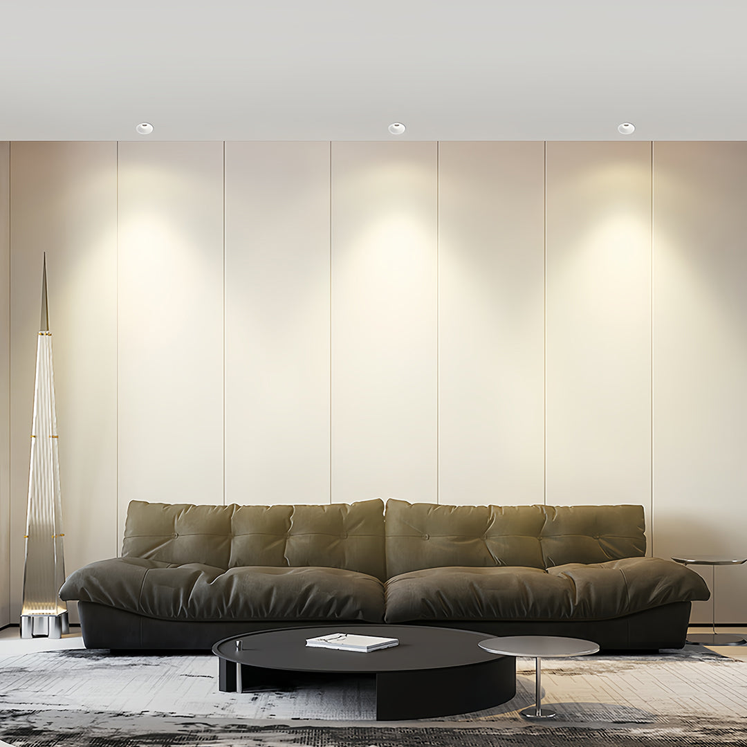 Row of trimless recessed downlights accenting landscape painting in luxurious beige bedroom suite