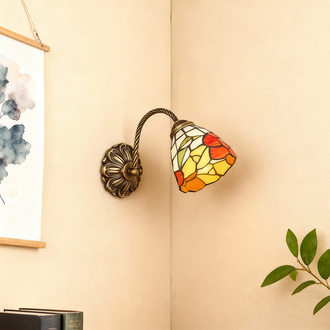 Artistic stained glass wall sconce lighting with glass shade chandelier aesthetic creating warm focal point in neutral hallway.