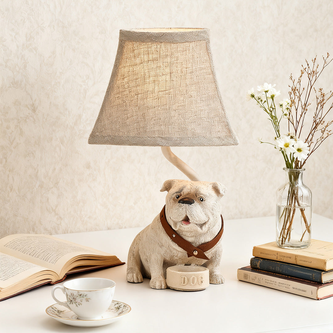 Rustic accent dog table lamps providing soft light for a cozy reading corner, placed next to books and a tea cup.