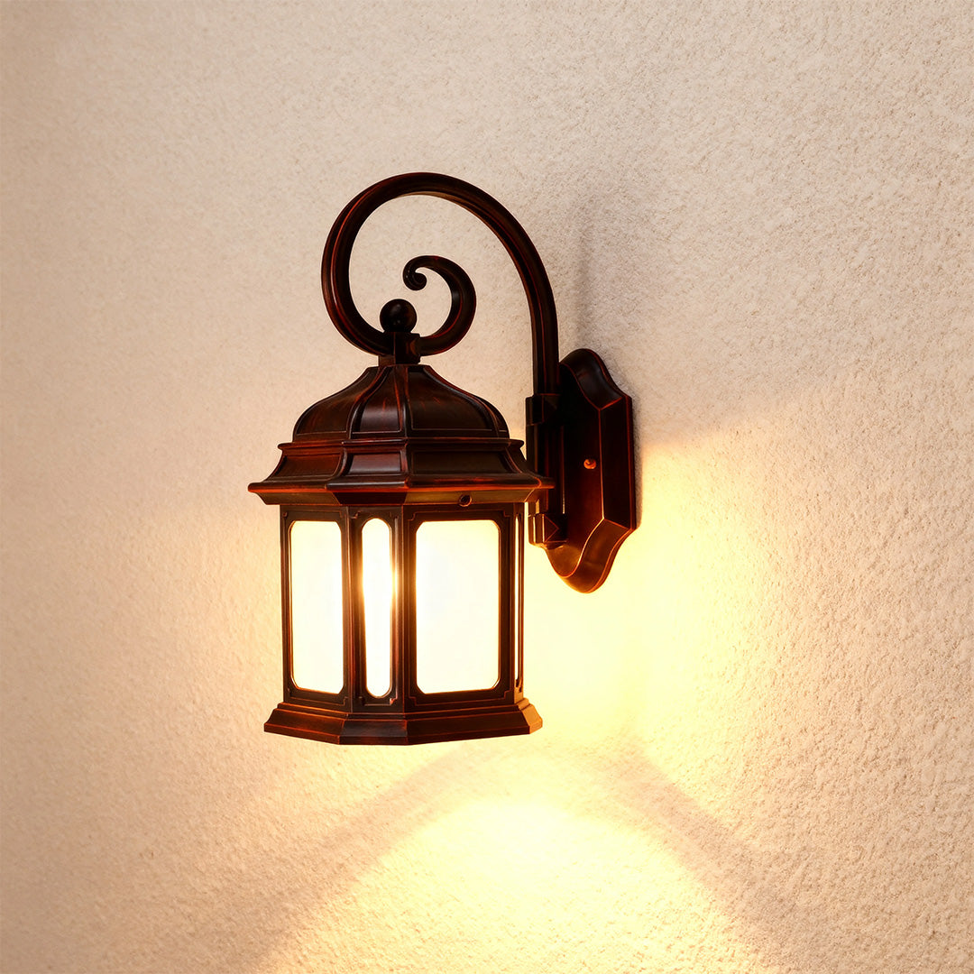 Rustic exterior LED wall light casting warm glow on beige stucco wall in evening setting