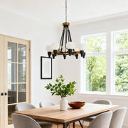 Rustic farmhouse 8 light chandeliers with a dark, geometric metal frame, installed in a vaulted ceiling above a large wooden dining table.