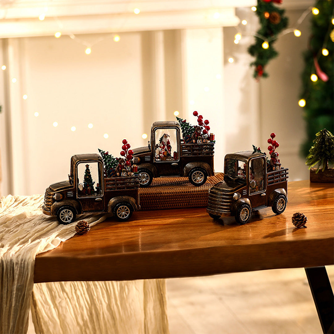 Rustic holiday truck collection with glowing scenes, styled with warm modern gold table lamp tones.