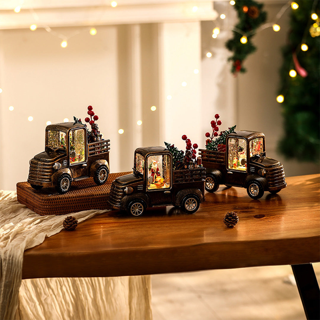 Rustic holiday truck collection with glowing scenes, styled with warm modern gold table lamp tones.