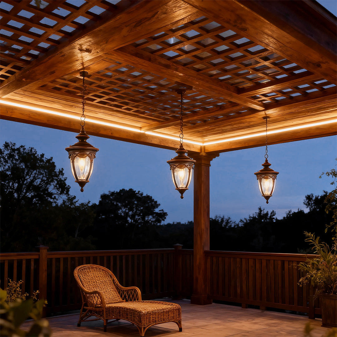 Rustic pendant porch lights illuminating wood-ceiling outdoor space at dusk with wicker lounger