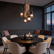 Rustic wood chandelier illuminating a modern dining room with warm, ambient glow.