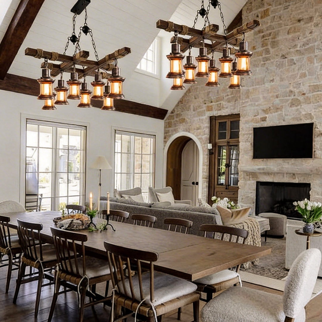 Large rustic wood chandelier lighting a long wooden dining table in open living space.