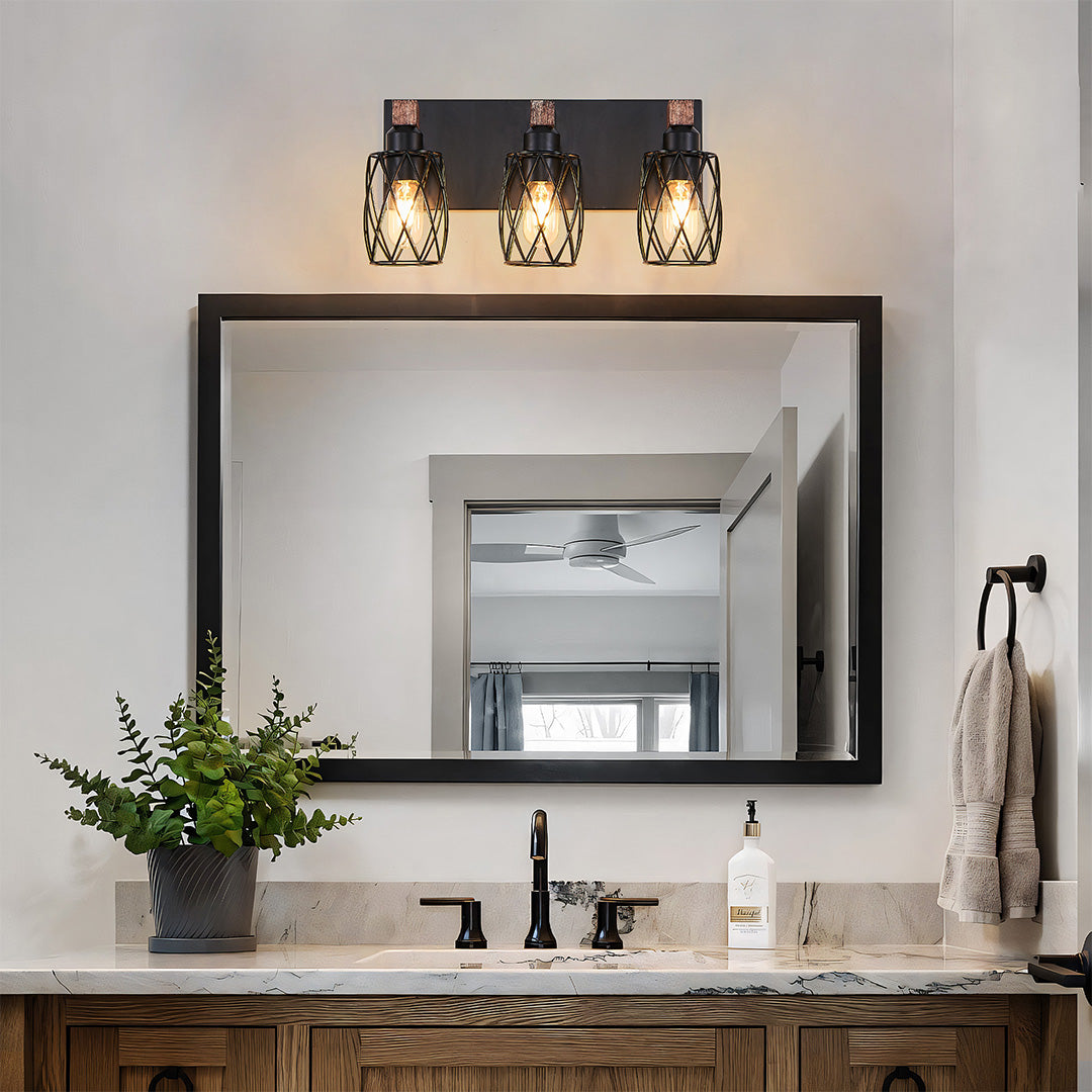 Black vanity bathroom light with three bulbs and a rustic wooden backplate, ideal for farmhouse-style bathrooms.