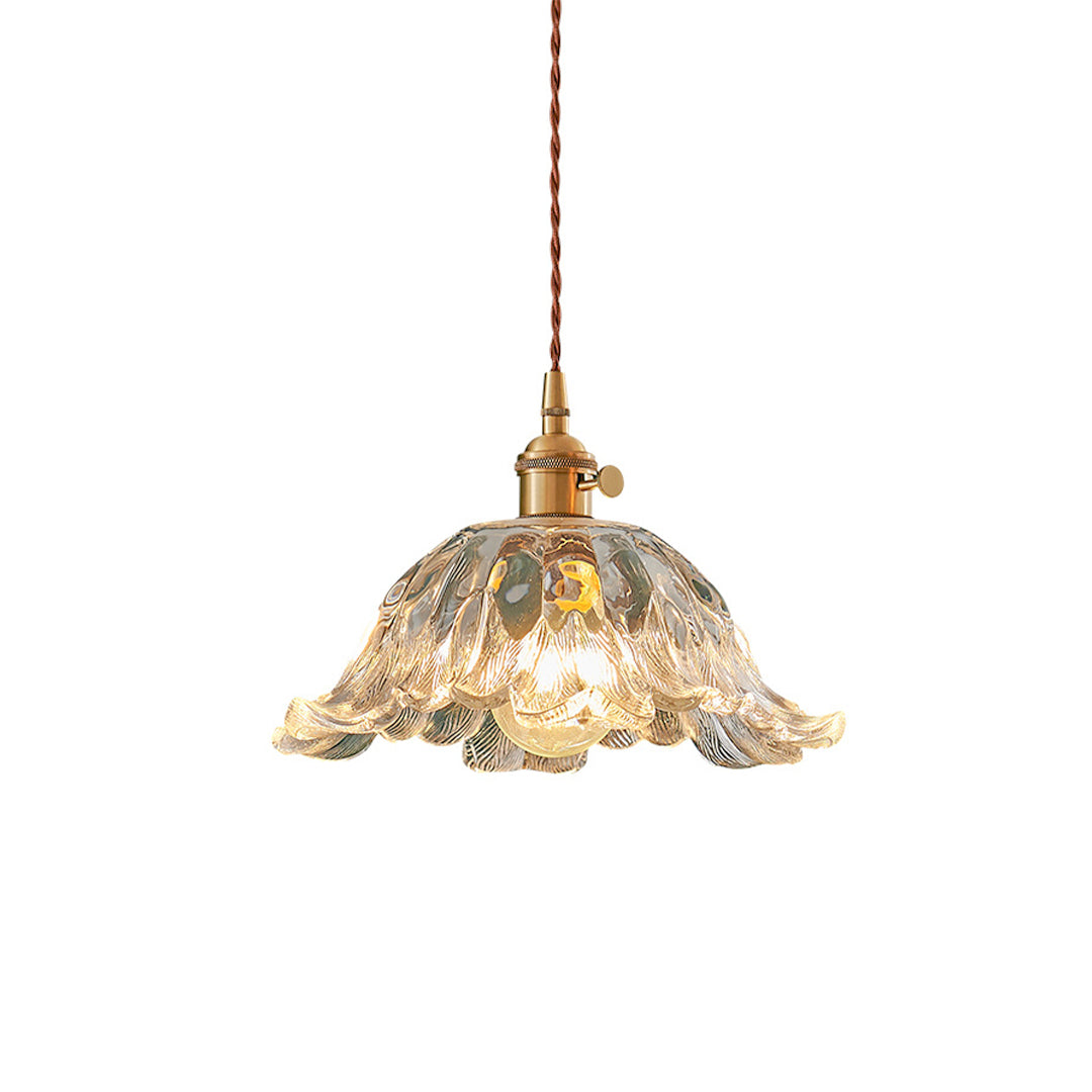 Elegant flower pendant lighting with scalloped glass shade and brass hardware creating decorative illumination.