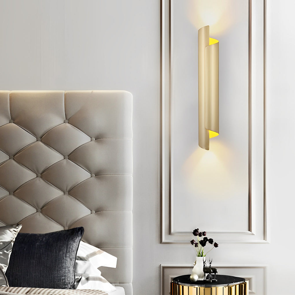 Scroll wall sconce in gold, mounted on a white wall, enhancing the elegance of a minimalist interior.
