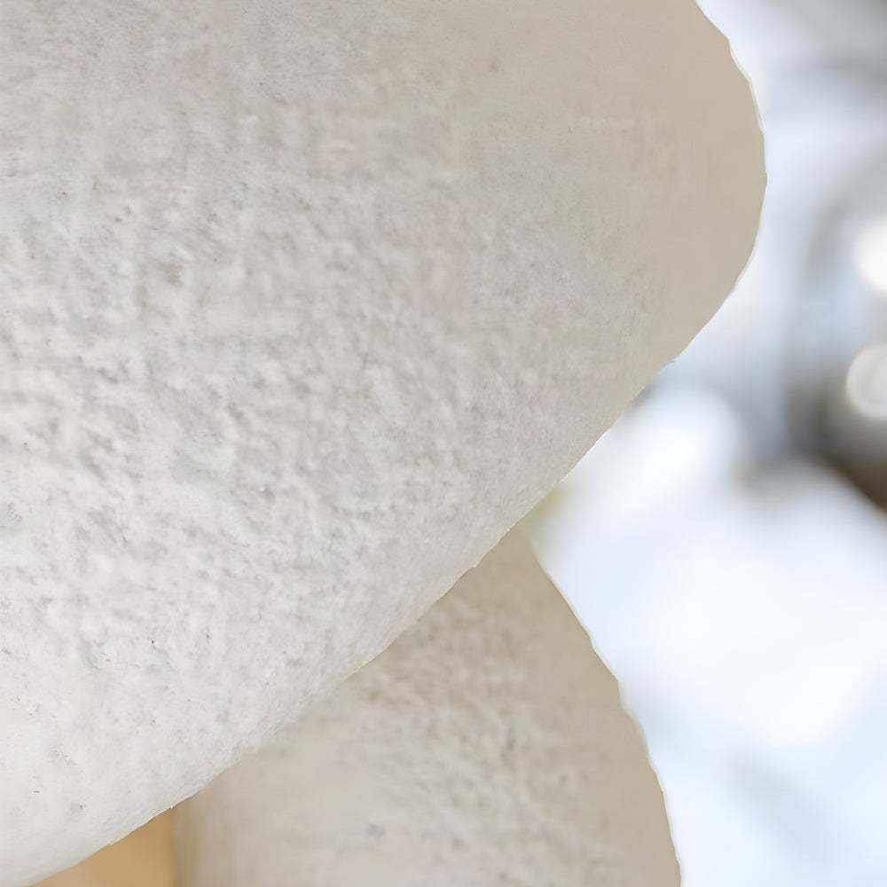 Sculptural LED wall lights featuring smooth rounded forms mounted on white wall creating artistic lighting display