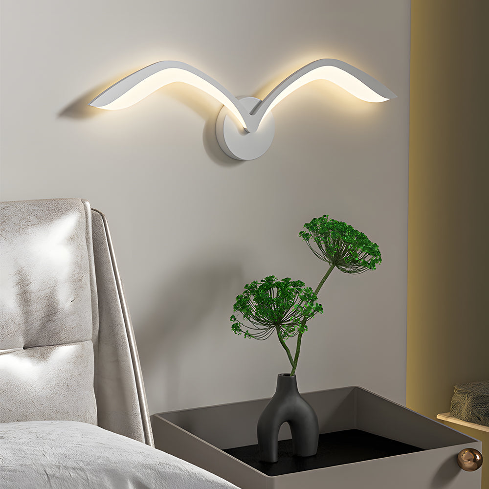 Seagull lighting sconces with a close-up of their curved wings and warm light.