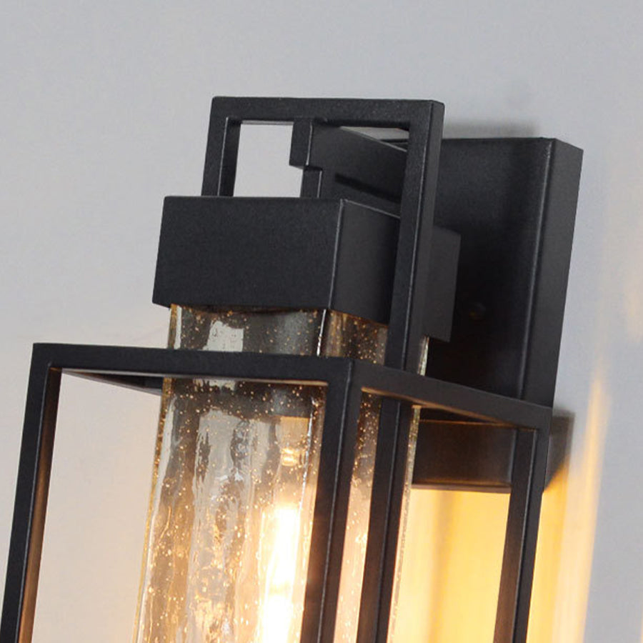 Detailed view of black metal lantern with seeded glass creating attractive light diffusion