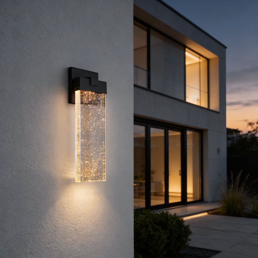 Seeded glass outdoor wall lighting installed on a modern building, casting soft light.