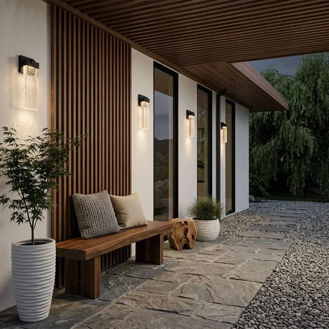Seeded glass outdoor wall lighting installed along a modern patio with a slim black frame and glowing textured glass.