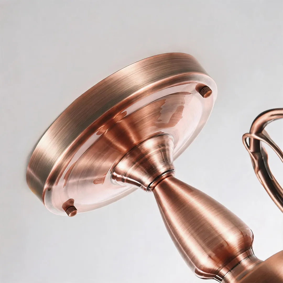 Close-up of the ceiling canopy and mounting hardware on a semi flush glass ceiling light in an antique copper finish.