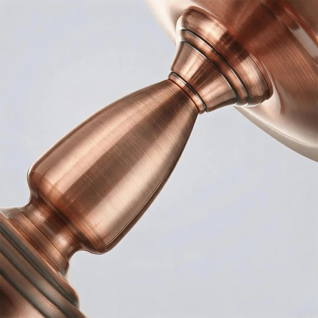 Close-up of the antique copper center stem on a semi flush glass ceiling light.
