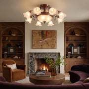 Semi flush glass ceiling light illuminating a traditional living room with a fireplace and warm wood shelving.