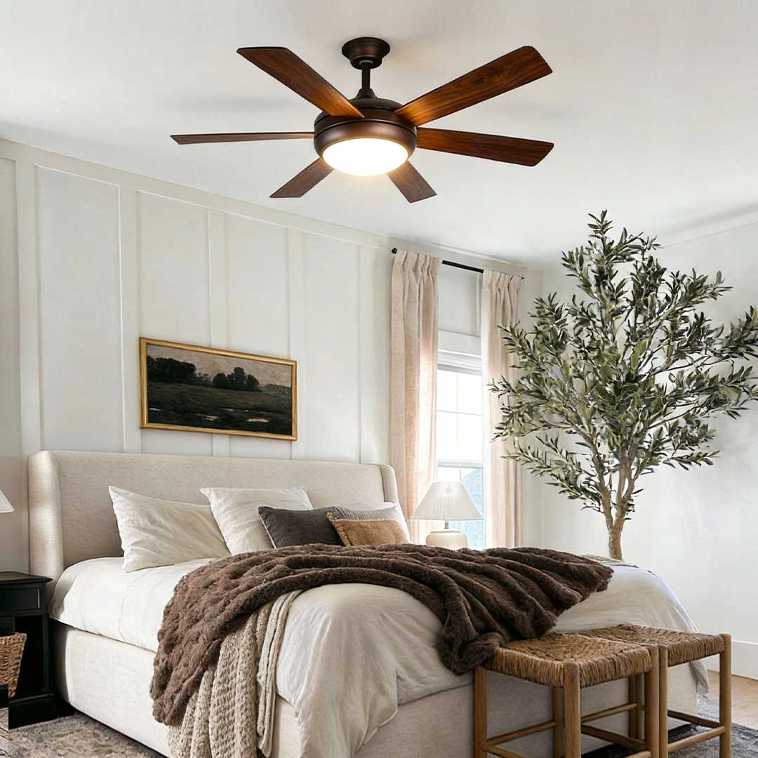 Semi-flush mount ceiling fan with light illuminating a stylish bedroom with a bed.
