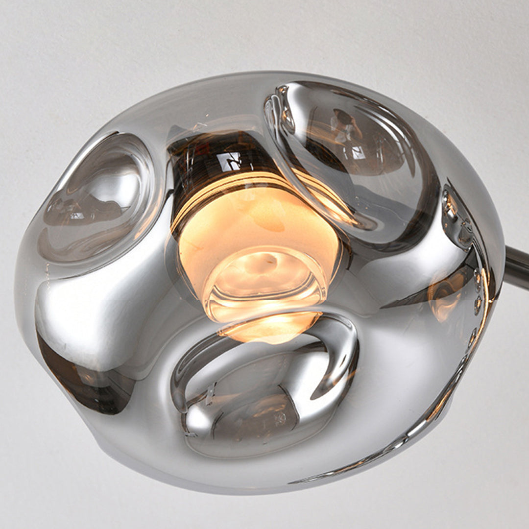 Close-up detail of large semi flush mount lighting showing individual chrome glass shade and LED bulb
