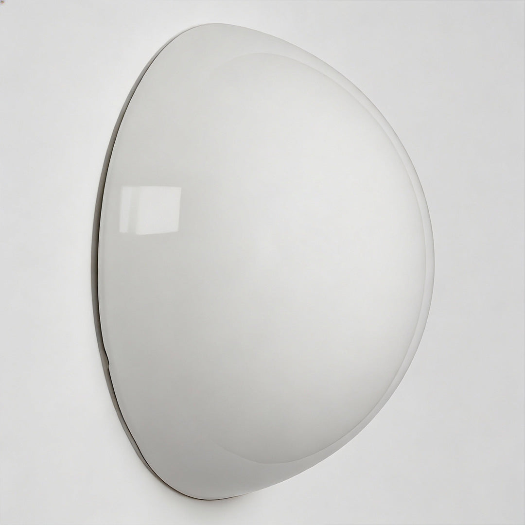 Sleek semi-spherical outdoor lighting wall mounted fixture with transparent edge, ideal for modern exterior spaces.