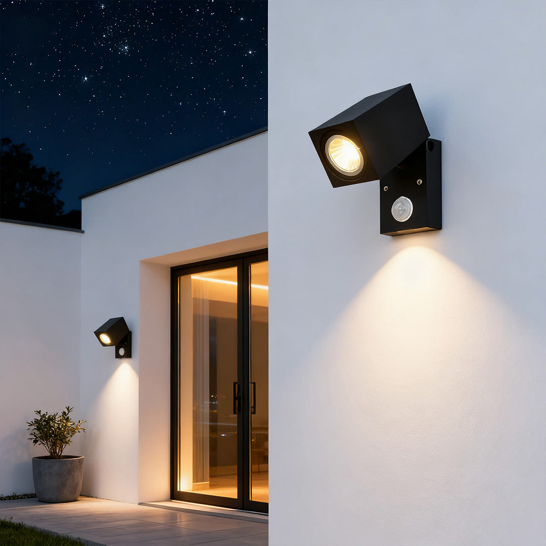 Outdoor sensor wall lights in black, providing bright illumination at night.