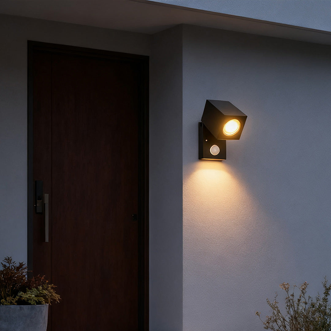 Sensor wall lights outdoor mounted beside a door, providing warm illumination and modern design.