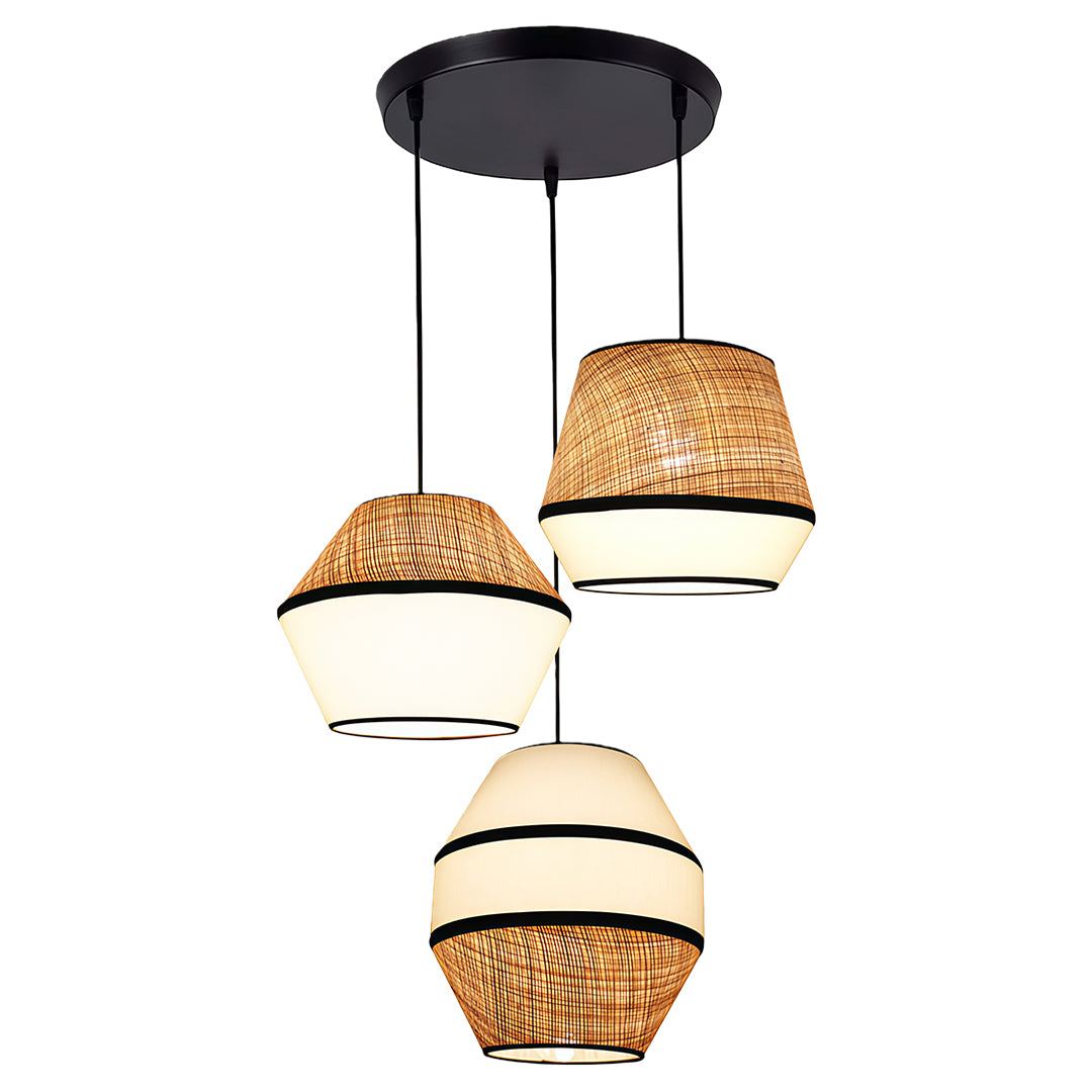 A series of pendant lights with fabric shades hanging in an open-concept kitchen, providing a warm glow.