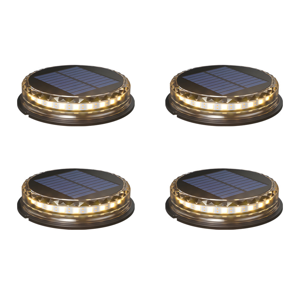 Set of four solar disc lights with illuminated LED rings, ready for outdoor installation.