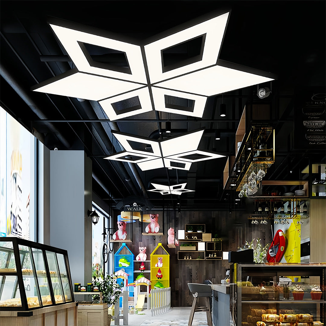 A modern black chandelier with clean lines and sharp geometric patterns, perfect for modern commercial interiors.